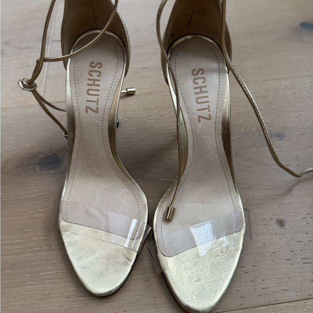 Schultz gold heels with clear straps